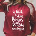 Book Reading A Book A Day Keeps Reality Away Raglan Sleeve Sweatshirt Heather Dust