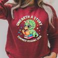 Dino Reading Books Unearth a Story Summer Reading Dinosaur Raglan Sleeve Sweatshirt Heather Dust Dino Reading Books Unearth a Story Summer Reading Dinosaur Raglan Sleeve Sweatshirt Heather Dust