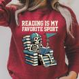Football Skeleton Reading On Book Stack Raglan Sleeve Sweatshirt Heather Dust