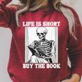 Life Is Short Buy The Book Skeleton Reading Book Raglan Sleeve Sweatshirt Heather Dust Life Is Short Buy The Book Skeleton Reading Book Raglan Sleeve Sweatshirt Heather Dust