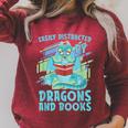 Reading Books Easily Distracted By Dragons And Books Raglan Sleeve Sweatshirt Heather Dust