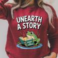 Unearth a Story Frog Reading a Book Summer 2026 Premium Tri-Blend Raglan Sleeve Sweatshirt Heather Dust Unearth a Story Frog Reading a Book Summer 2026 Premium Tri-Blend Raglan Sleeve Sweatshirt Heather Dust