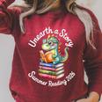 Unearth a Story Summer Reading 2026 Book Lover Dino Fun Raglan Sleeve Sweatshirt Heather Dust Unearth a Story Summer Reading 2026 Book Lover Dino Fun Raglan Sleeve Sweatshirt Heather Dust