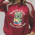 Unearth a Story Summer Reading 2026 Cute Dinosaur Book Lover Raglan Sleeve Sweatshirt Heather Dust