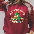 Unearth A Story Summer Reading 2026 Dinosaur Book Floral Raglan Sleeve Sweatshirt Heather Dust Unearth A Story Summer Reading 2026 Dinosaur Book Floral Raglan Sleeve Sweatshirt Heather Dust