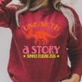 Unearth a Story Summer Reading 2026 Triceratops Dino Book Premium Tri-Blend Raglan Sleeve Sweatshirt Heather Dust Unearth a Story Summer Reading 2026 Triceratops Dino Book Premium Tri-Blend Raglan Sleeve Sweatshirt Heather Dust