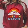 Unearth a Story Summer Reading 2026 Vintage Book Rainbow Raglan Sleeve Sweatshirt Heather Dust Unearth a Story Summer Reading 2026 Vintage Book Rainbow Raglan Sleeve Sweatshirt Heather Dust