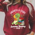 Unearth a Story Triceratops Dinosaur Reading Books Cute Dino Premium Tri-Blend Raglan Sleeve Sweatshirt Heather Dust