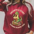 Unreath a Story Summer Library Reading 2026 Dinosaur Book Raglan Sleeve Sweatshirt Heather Dust