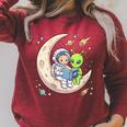Women's Astronaut Reading Book With Alien Moon Space Astronomy Raglan Sleeve Sweatshirt Heather Dust