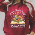 Women's New Chapter Begins Retired 2026 Watercolor Floral Book Women Raglan Sleeve Sweatshirt Heather Dust