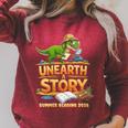 Women's Unearth a Story Dinosaur Reading Books Summer 2026 Raglan Sleeve Sweatshirt Heather Dust