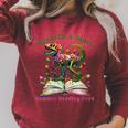 Women's Unearth A Story Summer Reading 2026 Dinosaur Book Floral Raglan Sleeve Sweatshirt Heather Dust