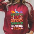 Women's Unearth A Story Summer Reading Program 2026 Dinosaur Book Raglan Sleeve Sweatshirt Heather Dust
