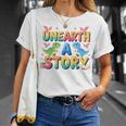 Summer Reading Unearth A Story Dinosaur Books 2026 T-Shirt Gifts for Her Summer Reading Unearth A Story Dinosaur Books 2026 T-Shirt Gifts for Her