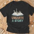Unearth A Story Skeleton Dinosaur Book Summer Reading 2026 T-Shirt Gifts for Old Men Unearth A Story Skeleton Dinosaur Book Summer Reading 2026 T-Shirt Gifts for Old Men