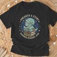 Unearth A Story Summer Reading 2026 Cute Dinosaur Reading T-Shirt Gifts for Old Men Unearth A Story Summer Reading 2026 Cute Dinosaur Reading T-Shirt Gifts for Old Men