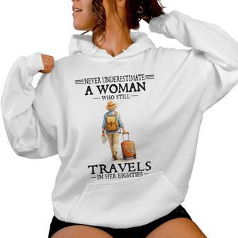 Never Underestimate A Woman Who Still Travels In Her Eightie Women Hoodie - Thegiftio UK