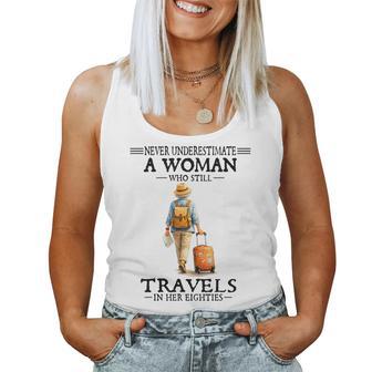 Never Underestimate A Woman Who Still Travels In Her Eightie Women Tank Top - Thegiftio UK