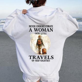 Never Underestimate A Woman Who Still Travels In Her 80'S Women Oversized Hoodie Back Print - Thegiftio UK
