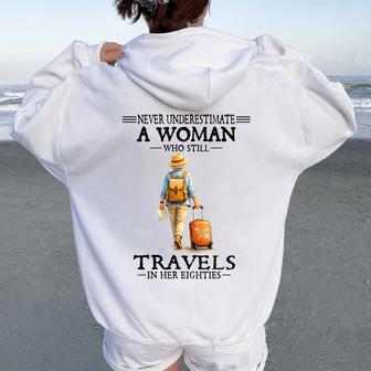 Never Underestimate A Woman Who Still Travels In Her Eightie Women Oversized Hoodie Back Print - Thegiftio UK