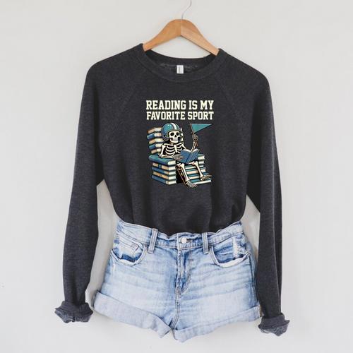 Football Skeleton Reading On Book Stack Raglan Sleeve Sweatshirt - Bookorys AU