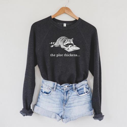 The Plot Thickens Raccoon Book Lover Raglan Sleeve Sweatshirt - Bookorys AU