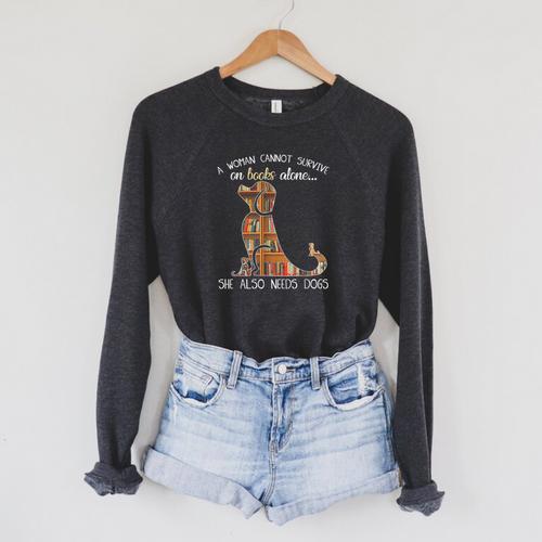 A Woman Cannot Survive On Books Alone She Also Needs Dogs Raglan Sleeve Sweatshirt - Bookorys DE