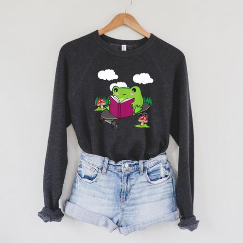 Cottagecore Aesthetic Cute Skateboarding Frog Reading Book Raglan Sleeve Sweatshirt - Bookorys
