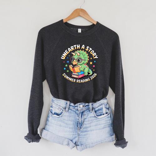 Dino Reading Books Unearth a Story Summer Reading Dinosaur Raglan Sleeve Sweatshirt - Bookorys