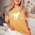 T-Rex Walking Jack Russel Divertente Cane Mamma Papà Dinosauro Trex T-shirt comoda oversize da donna Mustard