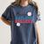Busy Raising Ballers Retro Groovy Baseball Mom Outfit Women's Comfort Colors T-Shirt Moss