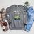 Unearth a Story Frog Reading a Book Summer 2026 Raglan Sleeve Sweatshirt Deep Heather