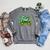 Unearth a Story Library Summer Reading 2026 Dinosaur Book Raglan Sleeve Sweatshirt Deep Heather