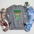 Women's Unearth a Story Summer Reading 2026 Triceratops Dino Book Raglan Sleeve Sweatshirt Deep Heather