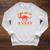 Unearth a Story Summer Reading 2026 Triceratops Dino Book Premium Tri-Blend Raglan Sleeve Sweatshirt Heather Mustard