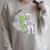 Astronaut Reading Book To Alien Moon Space Women Kids Men Premium Tri-Blend Raglan Sleeve Sweatshirt Heather Forest