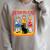 Caring For Your Evil Cat Retro Dark Humor Book Cover Premium Tri-Blend Raglan Sleeve Sweatshirt Heather Forest
