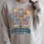 Color Our World Summer Reading 2025 Book Wildflowers Raglan Sleeve Sweatshirt Heather Forest