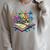 Enchanted Open Book With Blooming Flowers Raglan Sleeve Sweatshirt Heather Forest