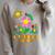 Eric Carle Let Kindness Bloom Flowers And Caterpillar Book Raglan Sleeve Sweatshirt Heather Forest Eric Carle Let Kindness Bloom Flowers And Caterpillar Book Raglan Sleeve Sweatshirt Heather Forest