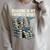 Football Skeleton Reading On Book Stack Raglan Sleeve Sweatshirt Heather Forest