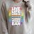 LGBTQ Quote Live Life Like A Banned Rainbow Book Raglan Sleeve Sweatshirt Heather Forest