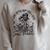 I Look Better Bent Over A Book Smut Reader Skeleton Women Raglan Sleeve Sweatshirt Heather Forest