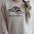 The Plot Thickens Raccoon Reading Book Bookish Raglan Sleeve Sweatshirt Heather Forest