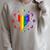 Rainbow Book With Stars And Moon Phases Gay Pride LGBT Raglan Sleeve Sweatshirt Heather Forest
