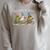 We Read At Dawn Book Lover Frog Duck Cycling Bookish Raglan Sleeve Sweatshirt Heather Forest