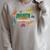 Summer Reading 2026 Unearth A Story Dinosaurs Book Lover Raglan Sleeve Sweatshirt Heather Forest Summer Reading 2026 Unearth A Story Dinosaurs Book Lover Raglan Sleeve Sweatshirt Heather Forest