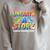 Summer Reading Unearth A Story Dinosaur Books 2026 Raglan Sleeve Sweatshirt Heather Forest