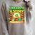 Unearth A Story Dinosaur Summer Reading 2026 Books Raglan Sleeve Sweatshirt Heather Forest